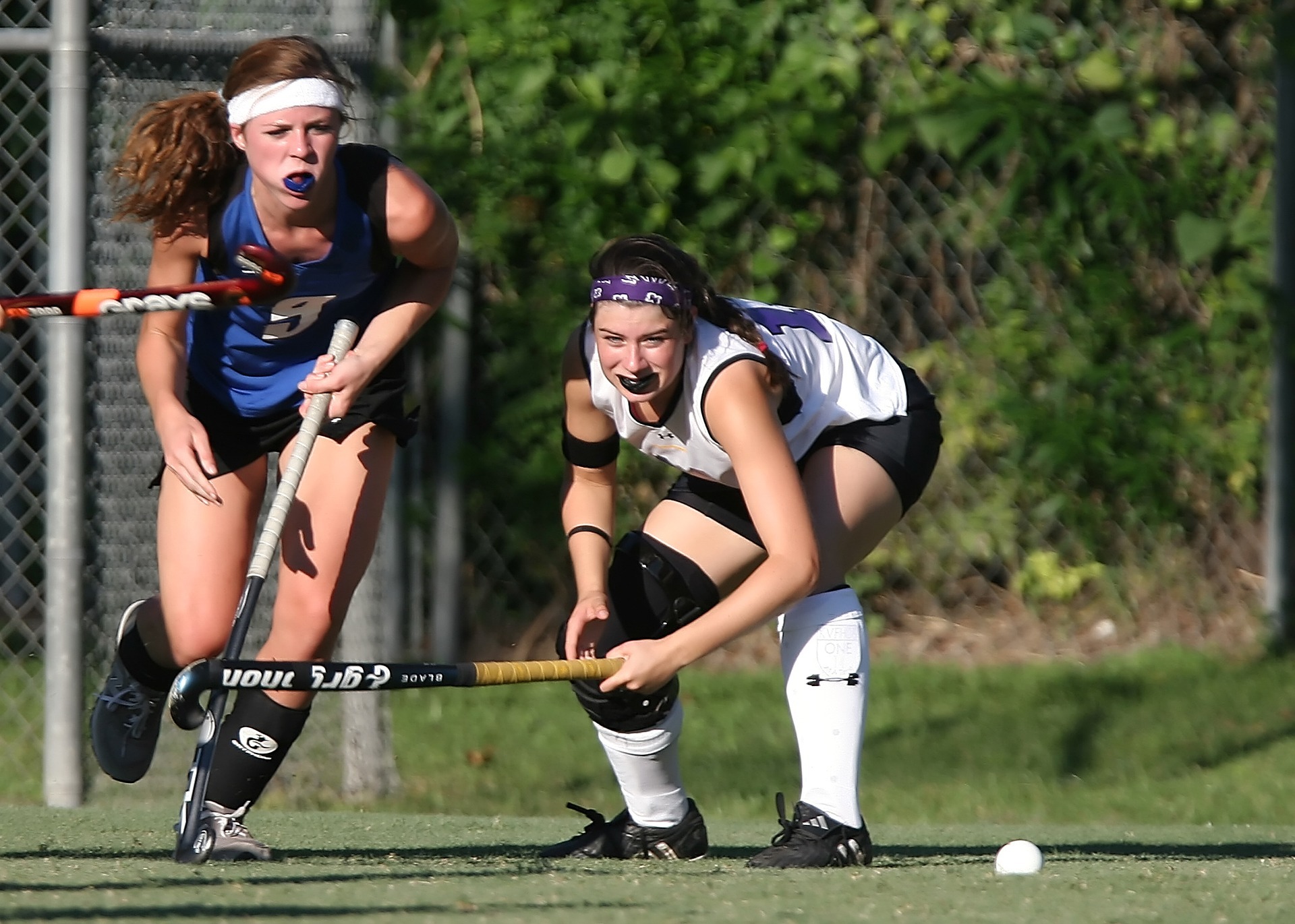 field hockey Field hockey players with hockey sticks running on pith and both have insurance for injury and their hockey sticks helmets and pads. Their club has signed up for an affiliate sports club insurance
