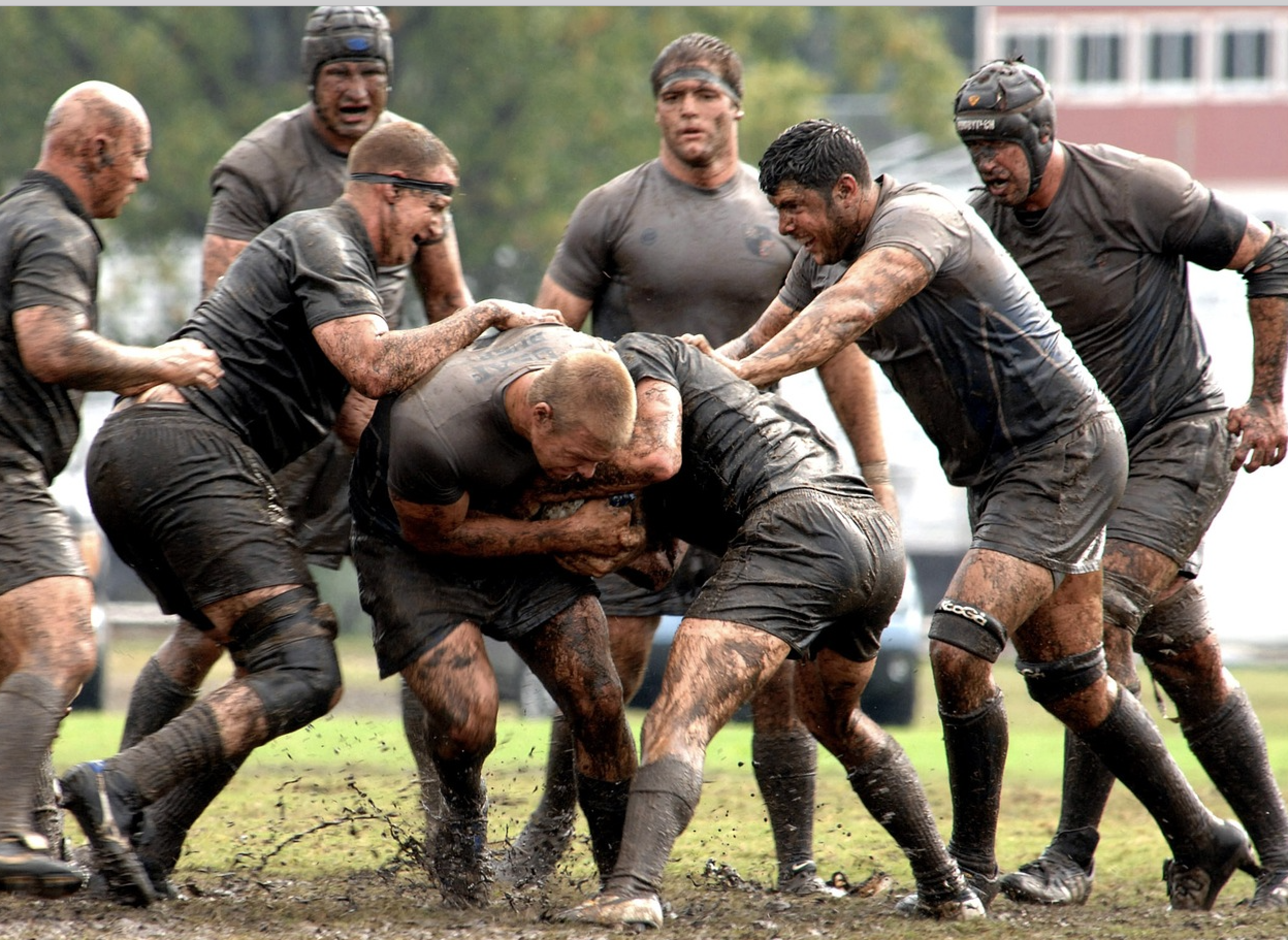 Tackling rugby players covered in mud who all have rugby insurance in case the worst happens, and their clubhouse is covered by rugby club insurance. Their club has signed up for an affiliate sports club insurance.